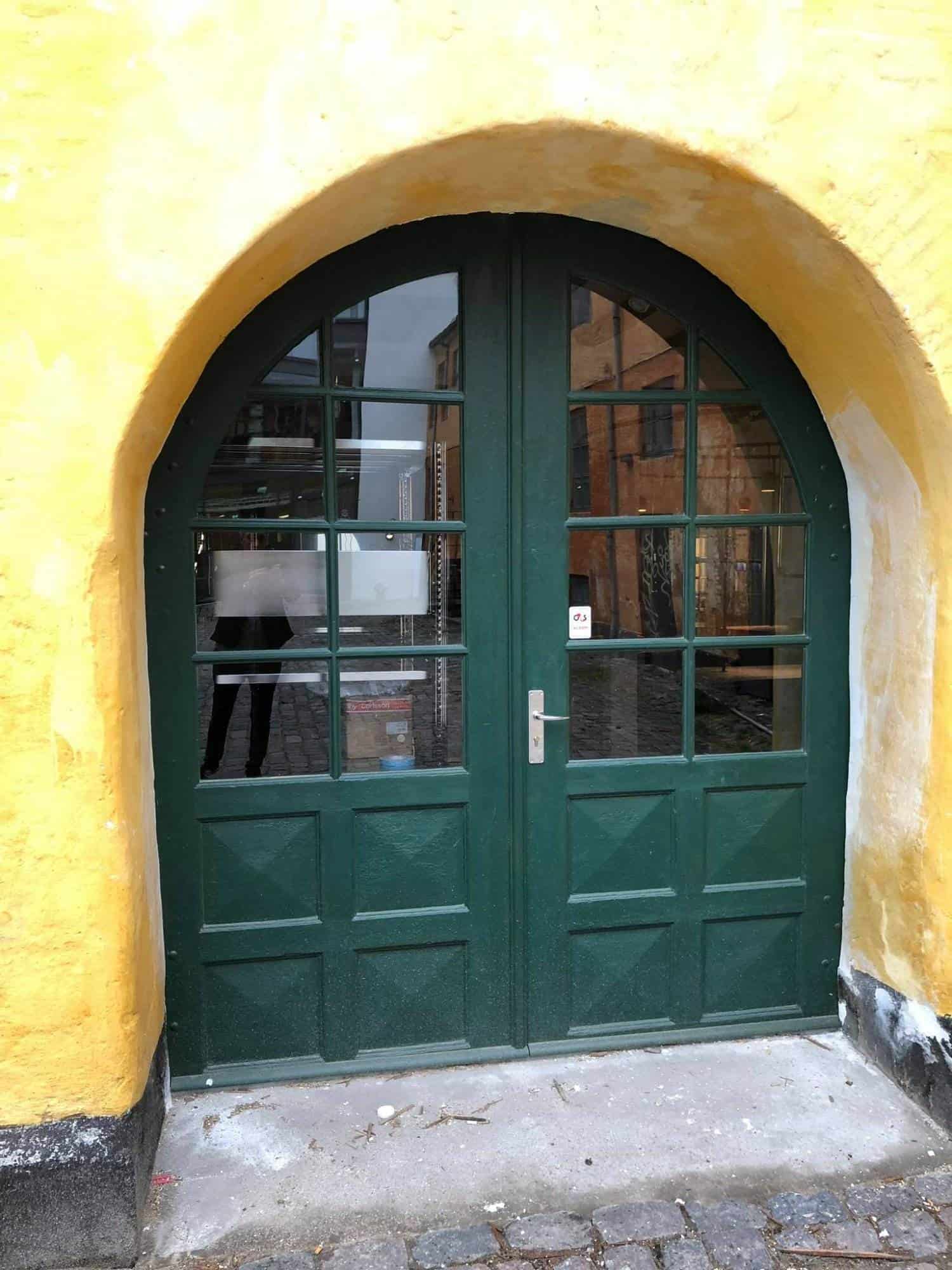 Havedør med buet top i grøn, perfekt til udendørs adgang.