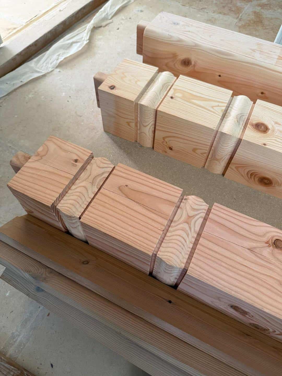 Nærbillede af træbjælker og træplanker til byggeri, klar til installation.